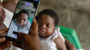 Sleeping baby has her facial biometrics captured via Simprints ID app