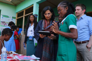 Gavi CEO Sania Nishtar interacts with a nurse of the Simprints biometric identity device
