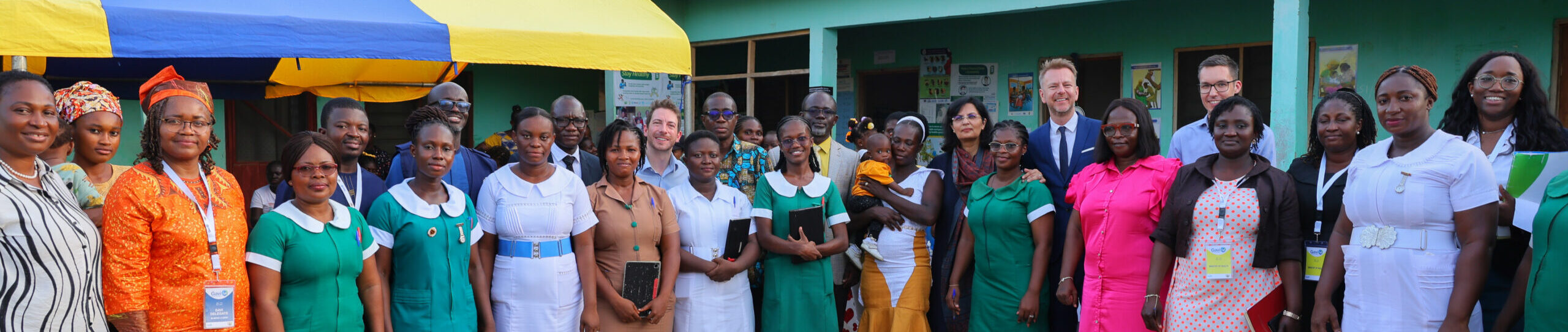 Gavi CEO Sania Nishtar photographed with health workers at the Ominako Community-Based Health Planning and Services (CHPS) facility in the Eastern Region of Ghana